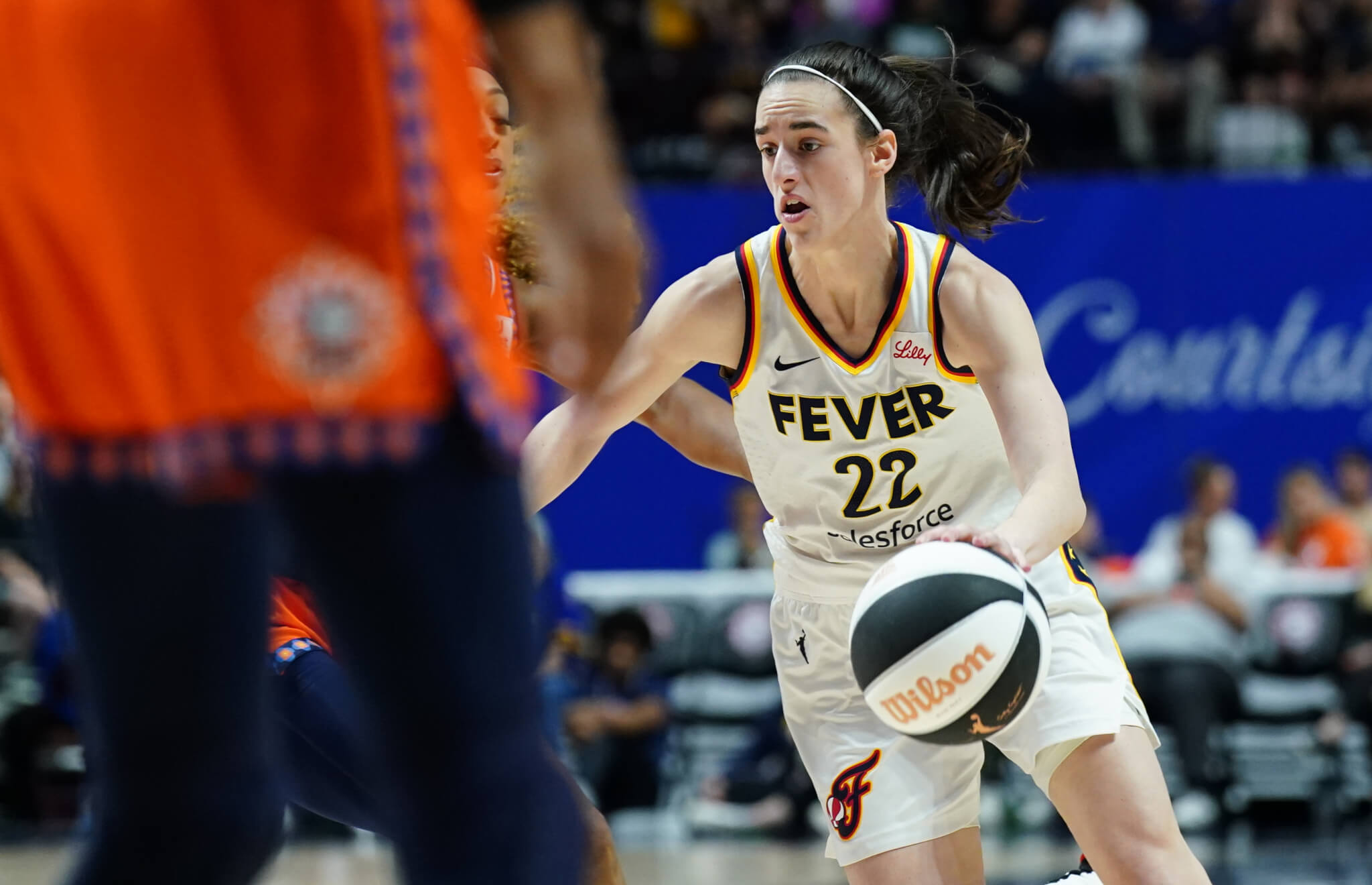 Indiana Fever guard Caitlin Clark dribbling up the court against the Connecticut Sun 