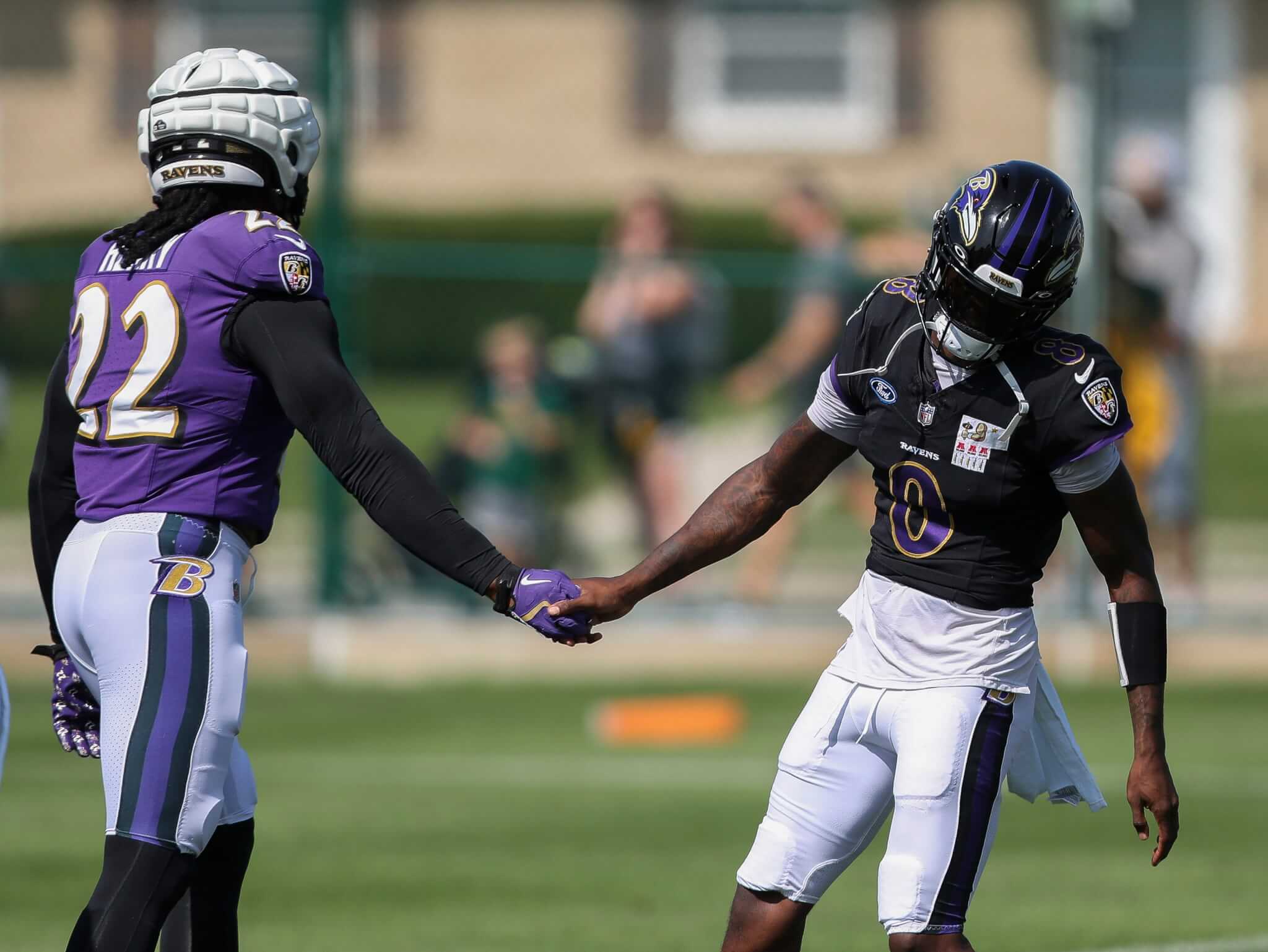 Lamar Jackson and Derrick Henry shaking hands at practice