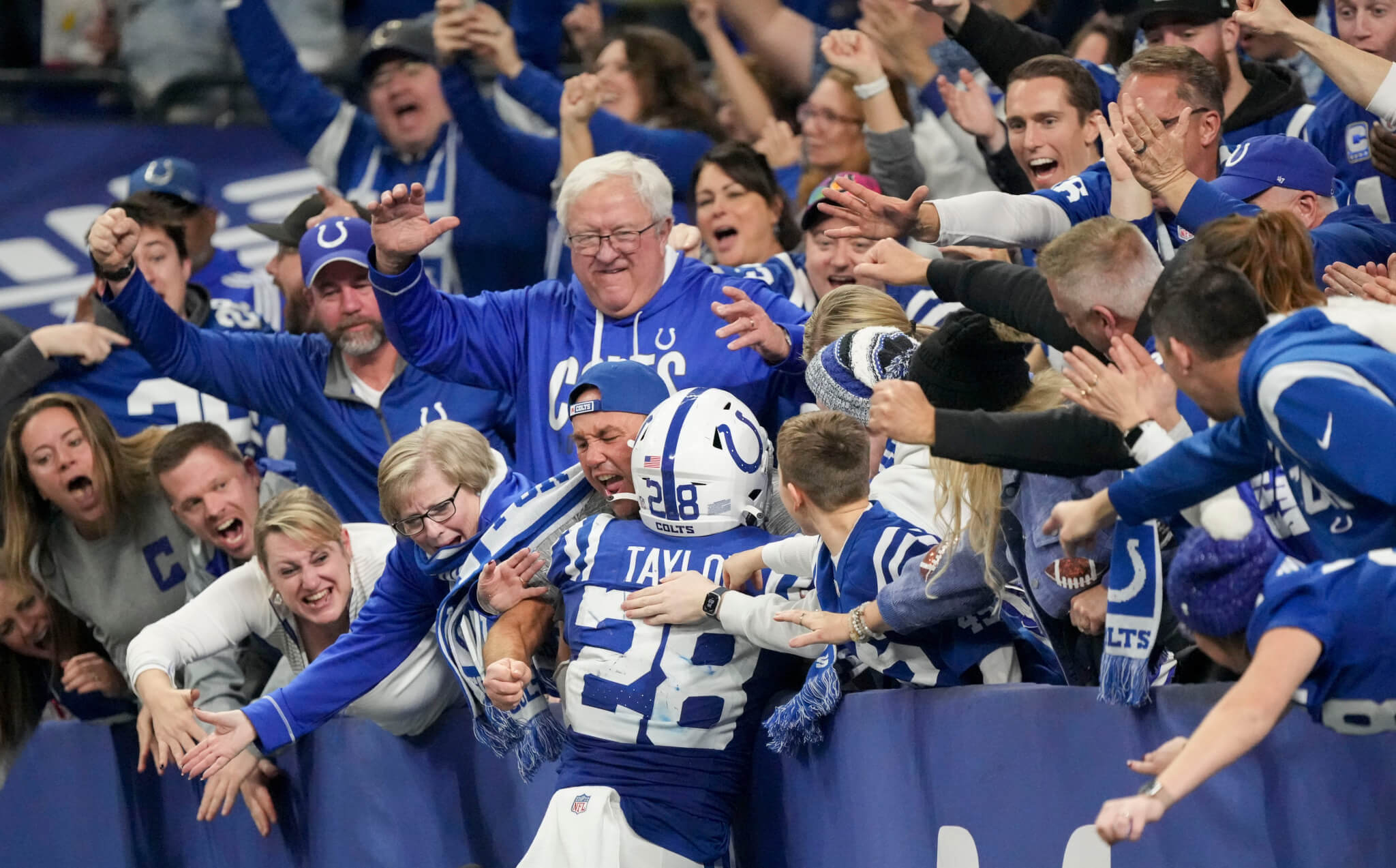 Jonathan Taylor jumping into the crowd after scoring a touchdown